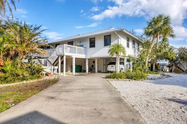 a view of a white house with a yard