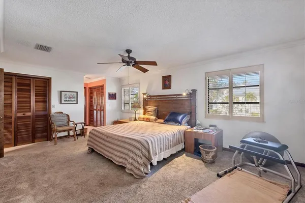 a bedroom with a bed couch and a window