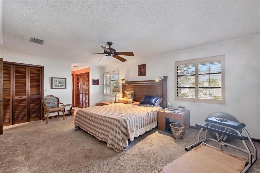 140 Damfino Street Boca Grande, FL 33921 - Photo 21 of 48 a bedroom with a bed couch and a window