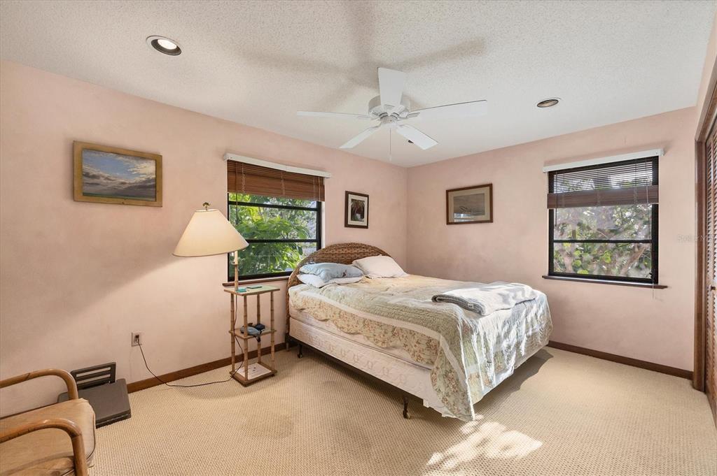 140 Damfino Street Boca Grande, FL 33921 - Photo 23 of 48 a bed room with a bed and a window