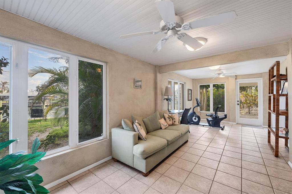 140 Damfino Street Boca Grande, FL 33921 - Photo 26 of 48 a living room with furniture and large windows