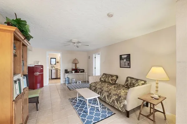 a living room with furniture a lamp and a window
