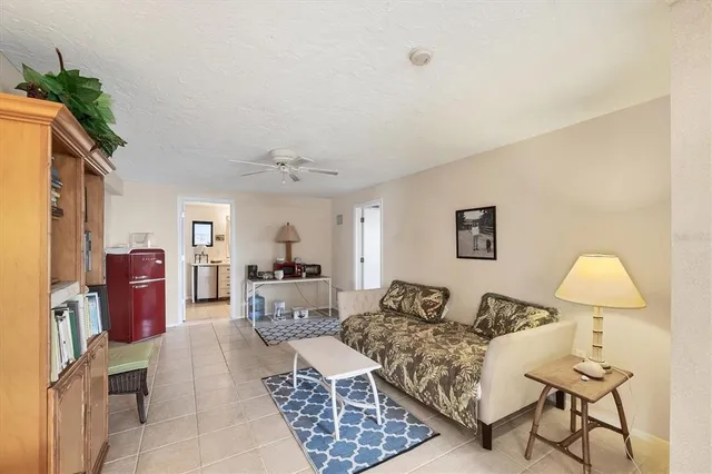 a living room with furniture a lamp and a window