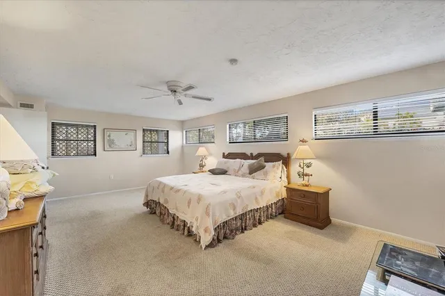 a spacious bedroom with a bed and a lamp