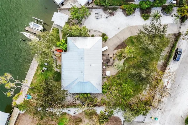 an aerial view of a house with a yard and trees