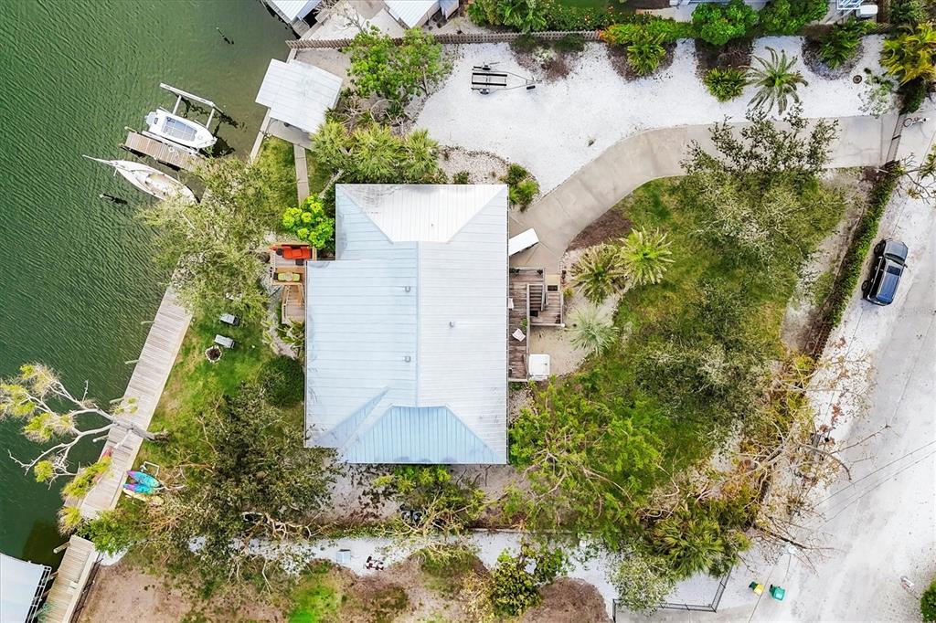 140 Damfino Street Boca Grande, FL 33921 - Photo 3 of 48 an aerial view of a house with a yard and trees