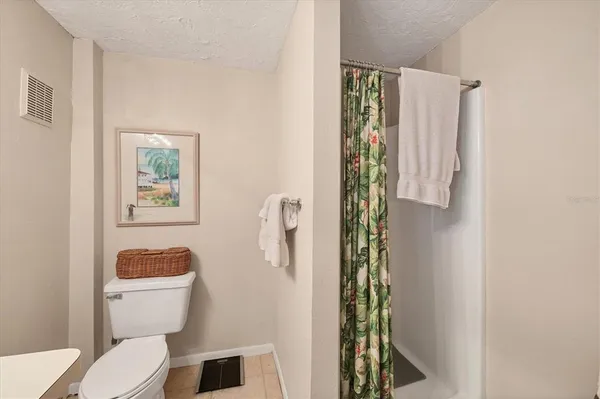 a white toilet sitting next to a bathroom sink