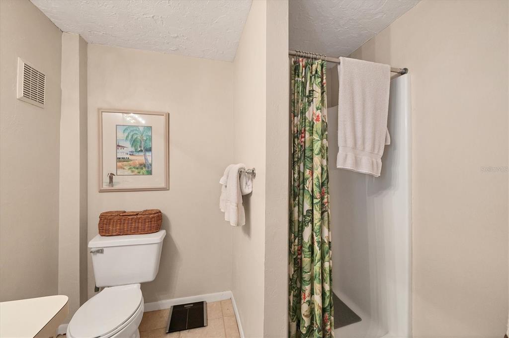 140 Damfino Street Boca Grande, FL 33921 - Photo 33 of 48 a white toilet sitting next to a bathroom sink