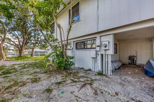 a backyard of a house with barbeque oven and table