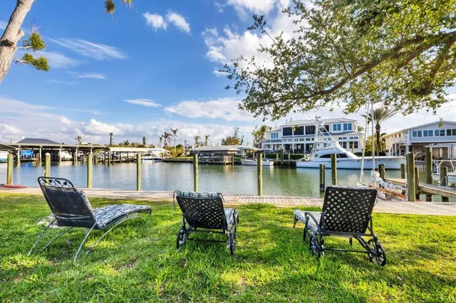 a view of a lake with a table and chairs