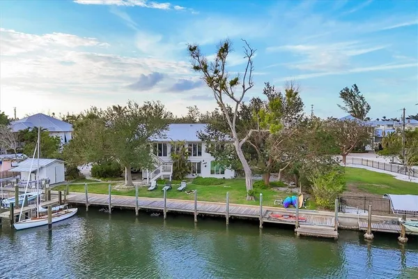 a view of house with swimming pool yard and outdoor seating