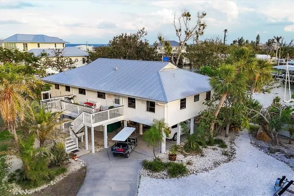 an aerial view of a house with garden space and sitting area