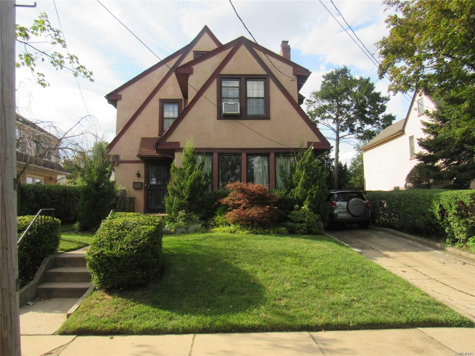 112-23 68th Road Queens, NY 11375 - Photo 1 of 1 a front view of a house with garden