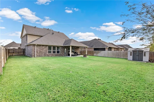 a view of a house with backyard and porch