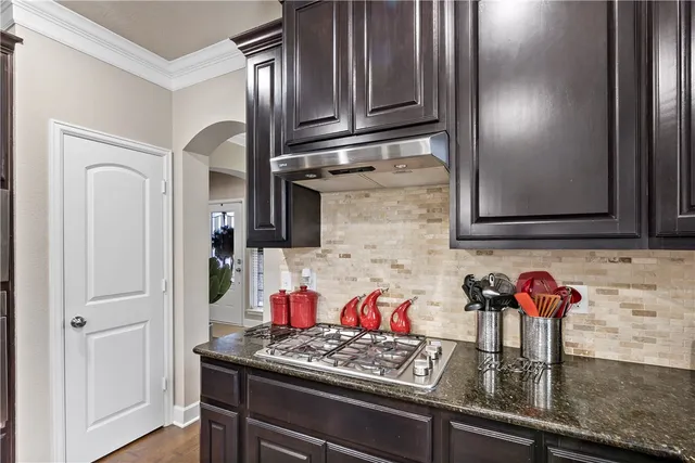 a kitchen with stainless steel appliances granite countertop a refrigerator stove and microwave