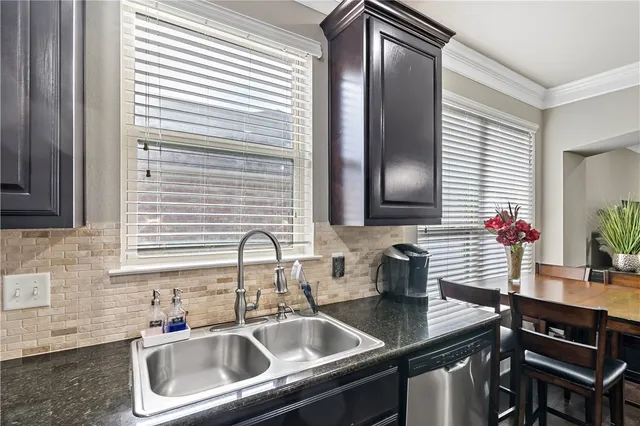 a kitchen with refrigerator cabinets and wooden floor