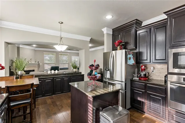 a kitchen with a potted plant on the counter and cabinets