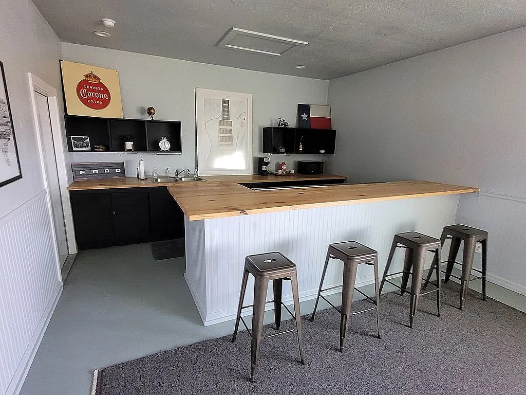 1102 Beech Street Taylor, TX 76574 - Photo 18 of 38 a kitchen with kitchen island granite countertop a stove top oven a sink a dining table and chairs
