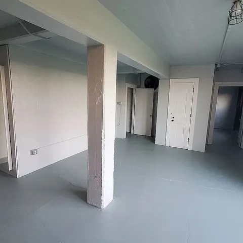 a view of a livingroom with fireplace and window