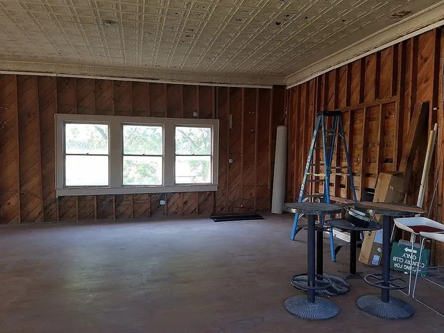 a view of a house with wooden deck and a flat screen tv