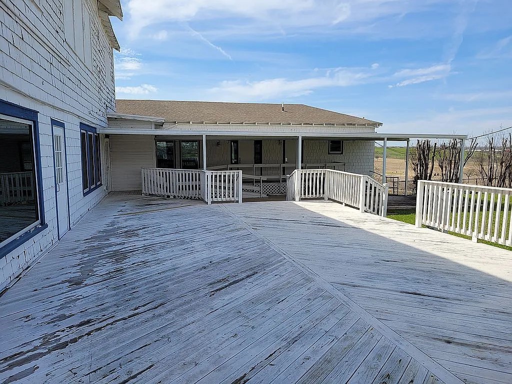1102 Beech Street Taylor, TX 76574 - Photo 32 of 38 a view of a house with wooden deck and a flat screen tv