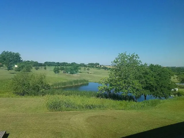 a living room with pool table and a floor to ceiling window