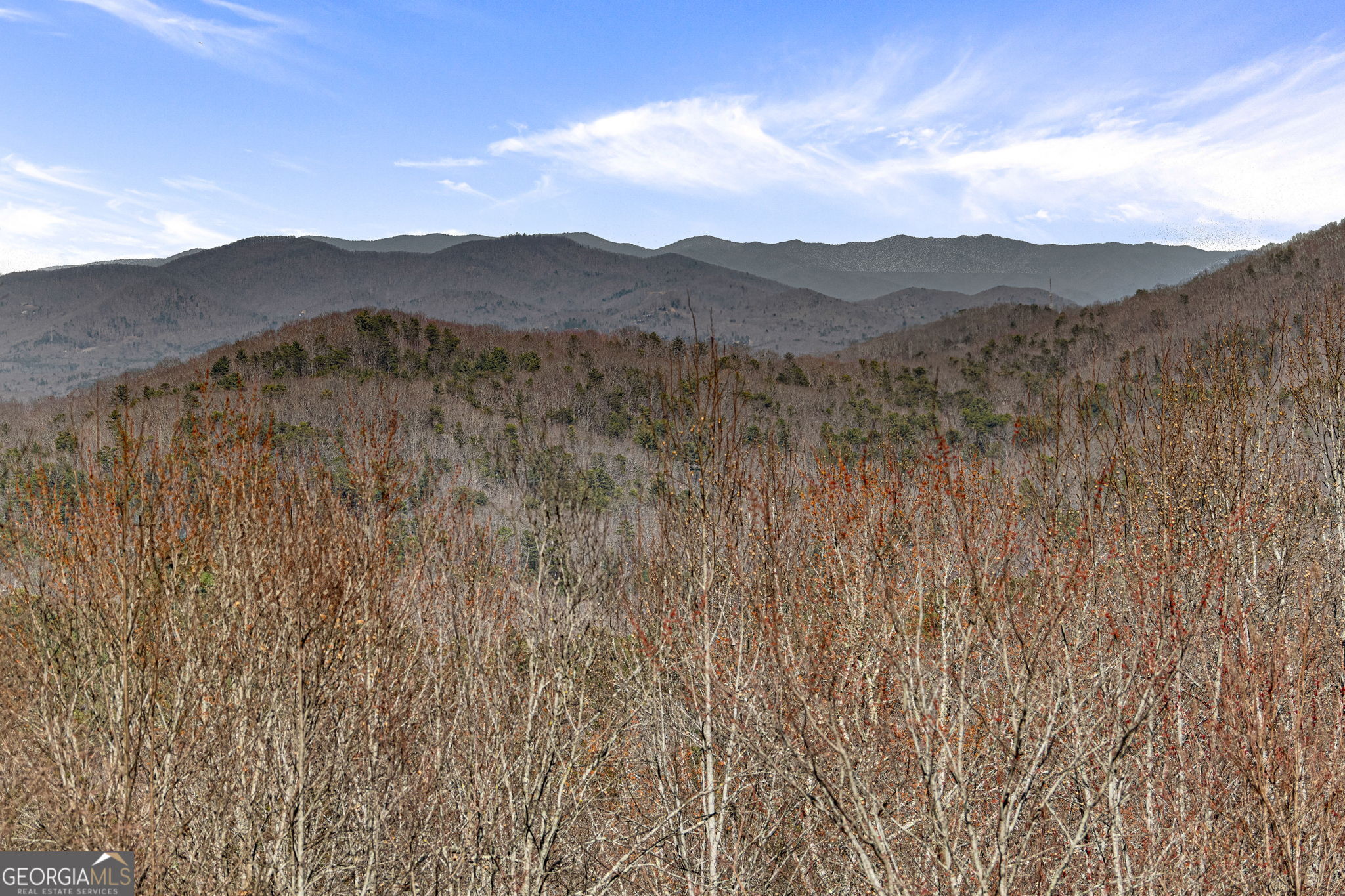 a view of a town with mountains in the background
