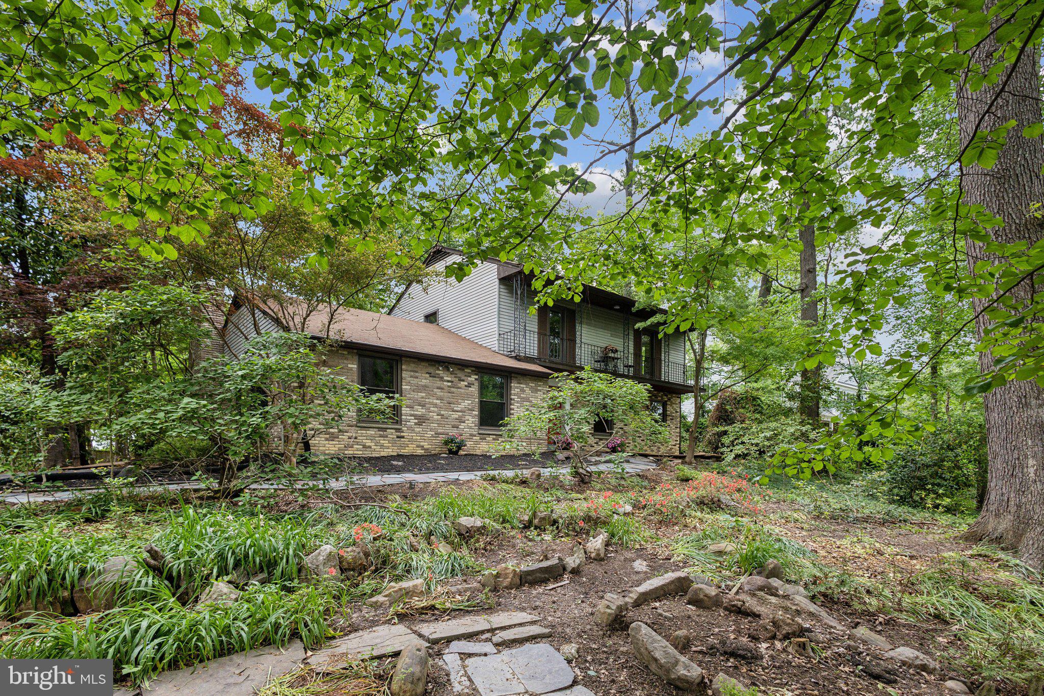 5936 River Drive Lorton, VA 22079 - Photo 2 of 19 a house is sitting in middle of forest