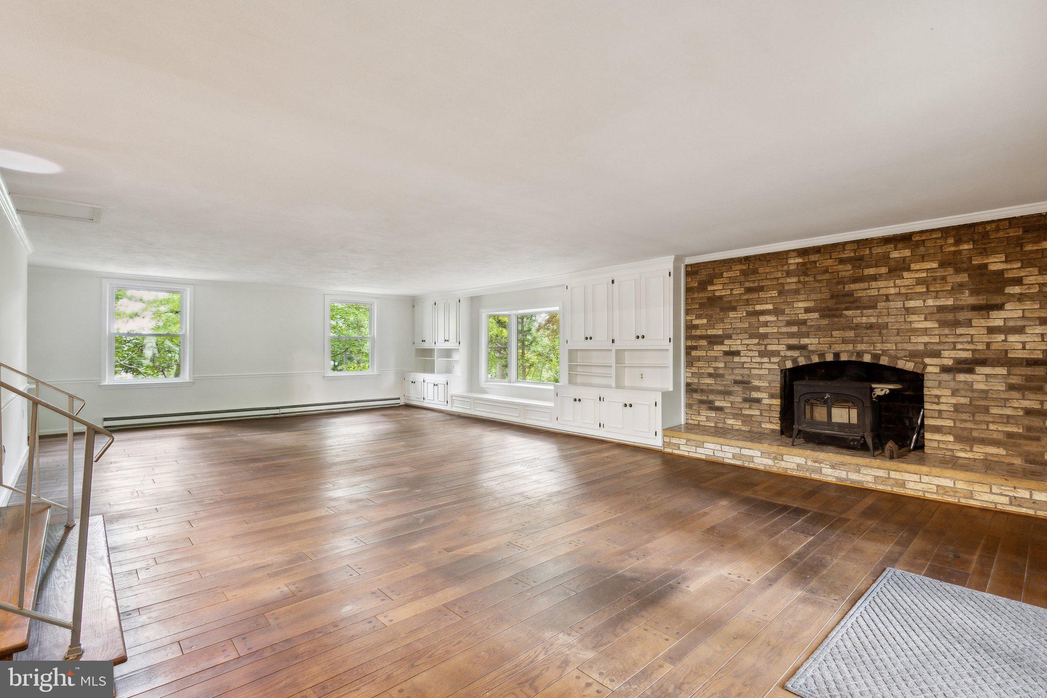 5936 River Drive Lorton, VA 22079 - Photo 4 of 19 an empty room with windows and fireplace