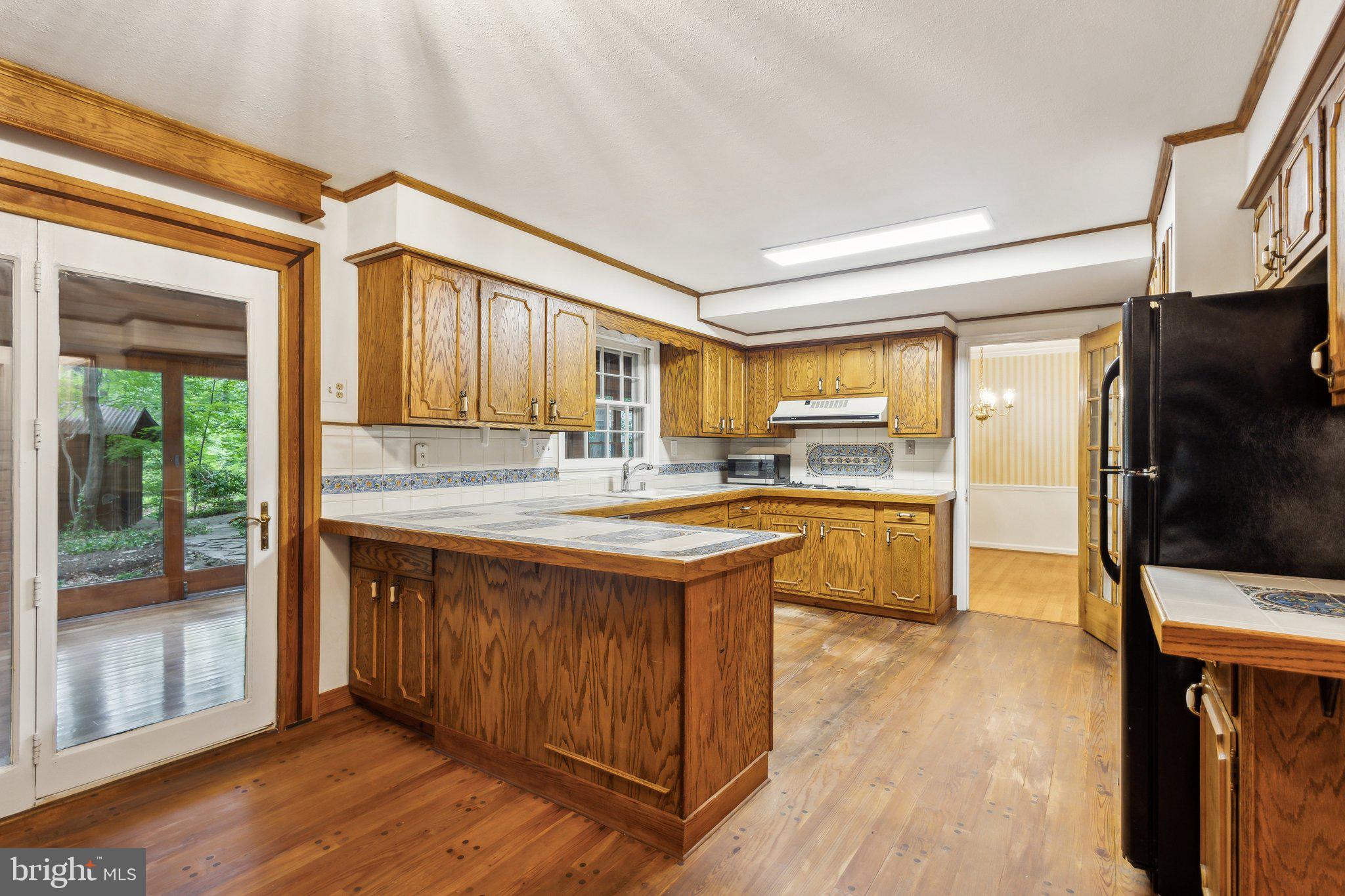 5936 River Drive Lorton, VA 22079 - Photo 6 of 19 a kitchen with stainless steel appliances granite countertop a stove and a refrigerator