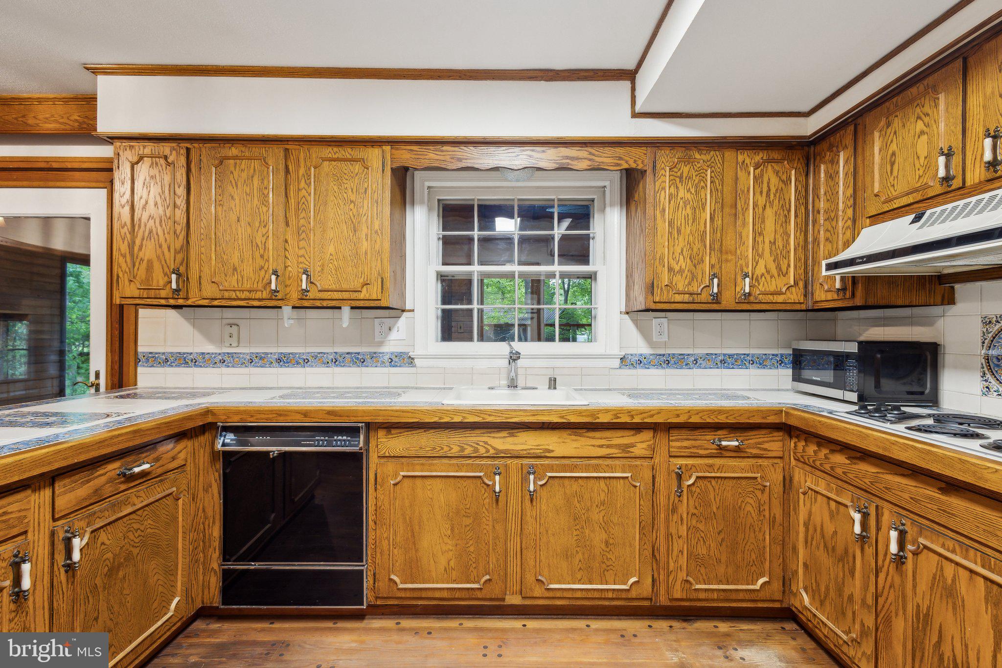 5936 River Drive Lorton, VA 22079 - Photo 7 of 19 a kitchen with stainless steel appliances granite countertop a sink and cabinets