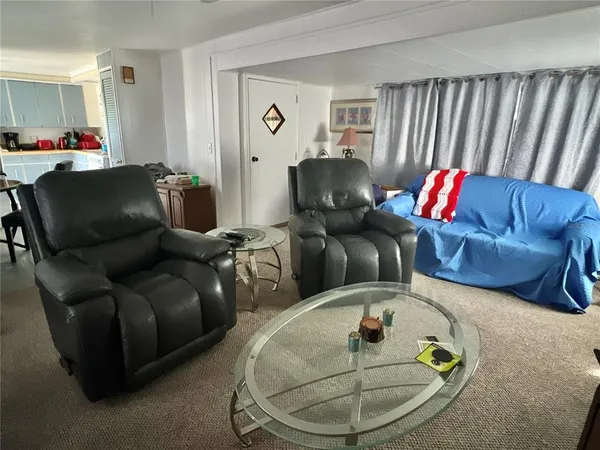 a living room with furniture and a mirror