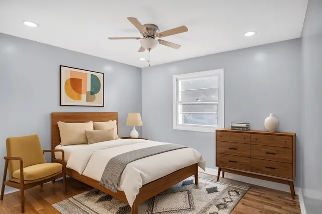 a bedroom with a bed and window