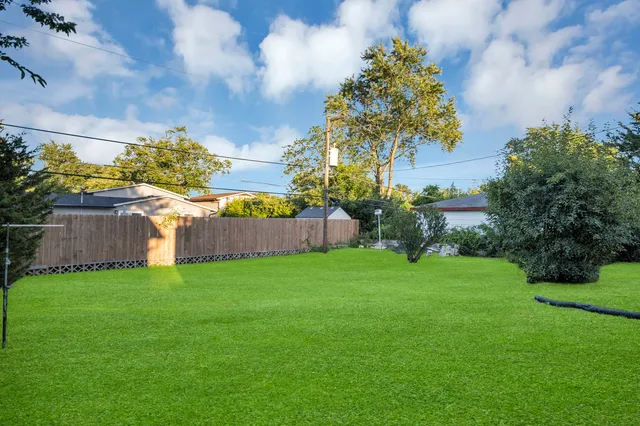 a view of a garden with a building in the background