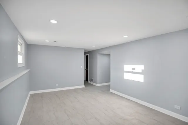 a view of an empty room with a window