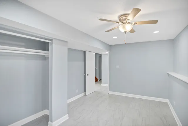 a view of an empty room with a fan