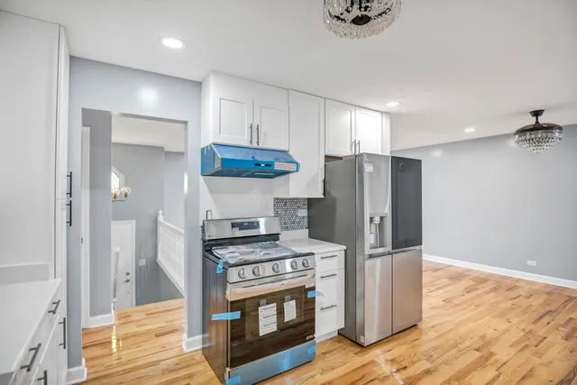 a kitchen with stainless steel appliances a refrigerator and a stove