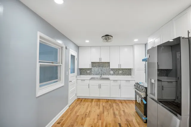 a kitchen with a sink stainless steel appliances and counter space