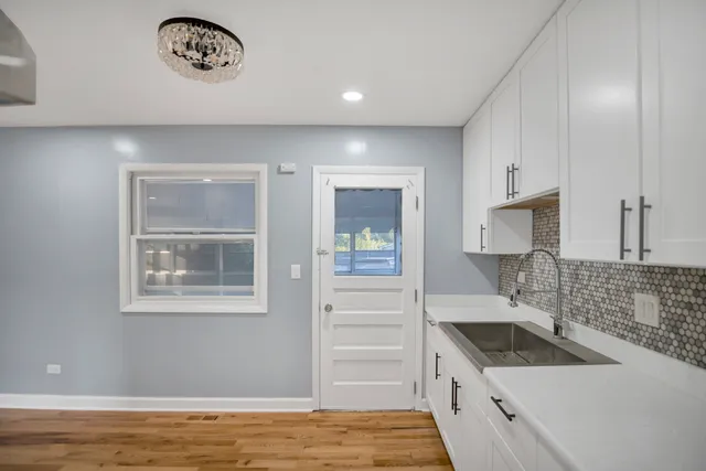 a kitchen with a sink cabinets and window