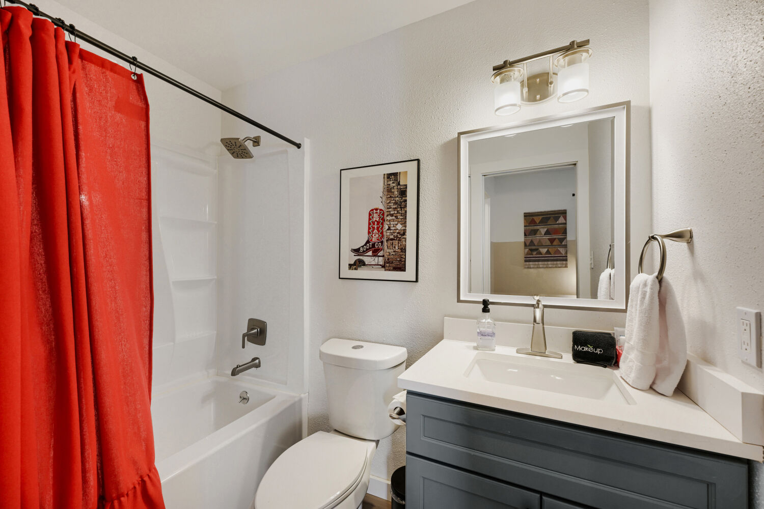 3410 Plantation Road Austin, TX 78745 - Photo 22 of 33 A well-appointed bathroom features a combined shower and tub, complemented by a sleek vanity and wall-mounted mirror.