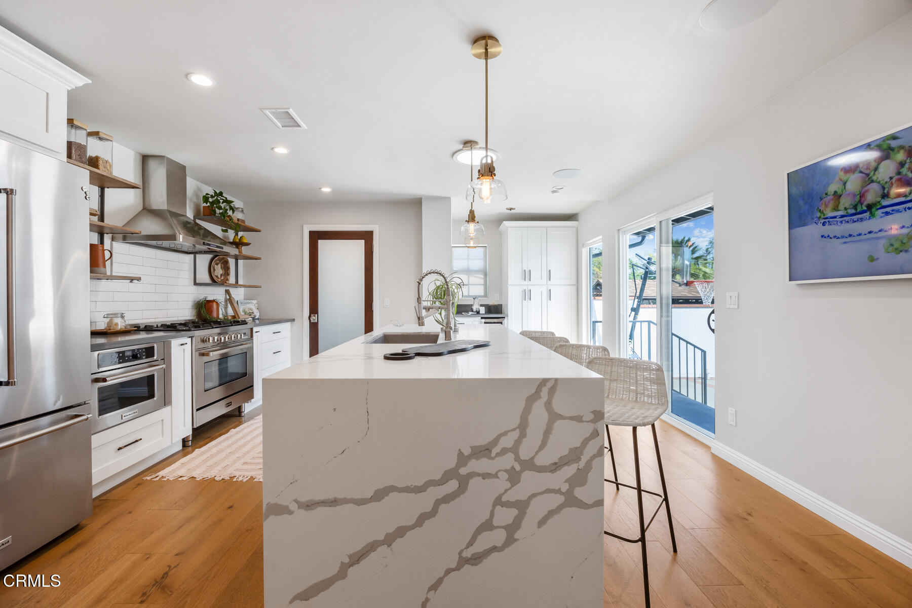 2386 Galbreth Road Pasadena, CA 91104 - Photo 18 of 63 a large kitchen with kitchen island a stove a sink a refrigerator and a wooden floor