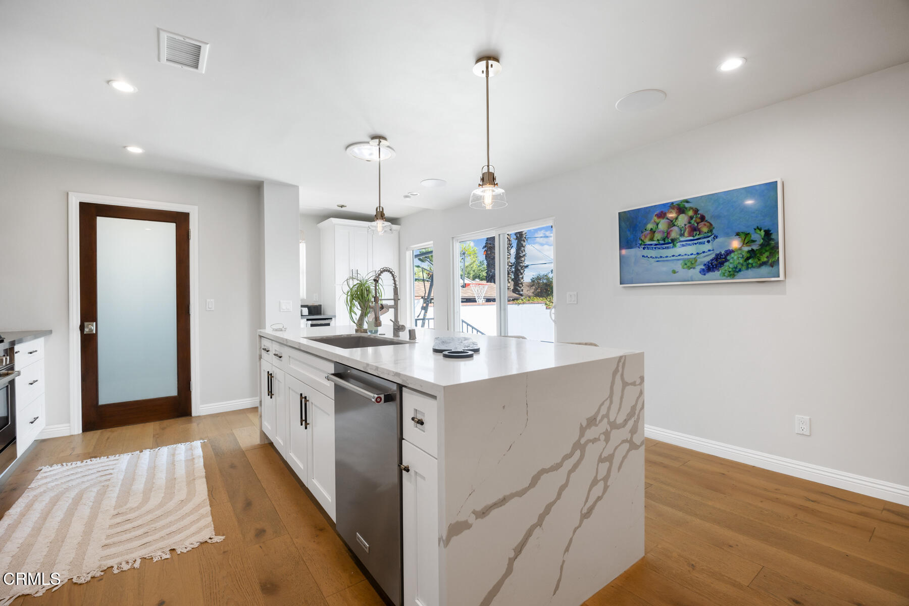 2386 Galbreth Road Pasadena, CA 91104 - Photo 19 of 63 a kitchen with stainless steel appliances kitchen island a cabinets and wooden floor