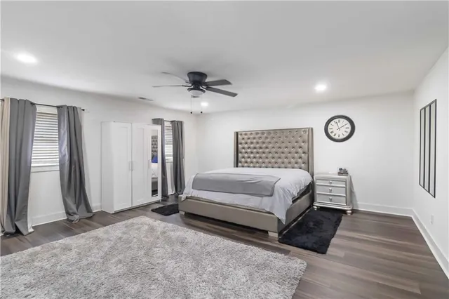 a spacious bedroom with a bed and a chandelier