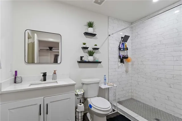 a bathroom with a sink toilet and shower