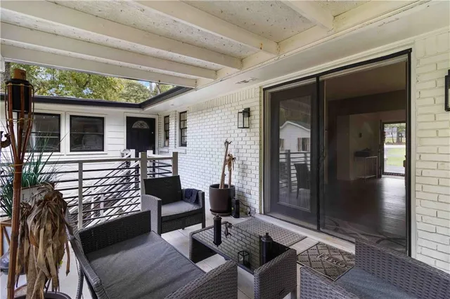 a view of house with outdoor space and a forest