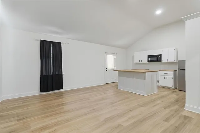 a white toilet sitting next to a shower
