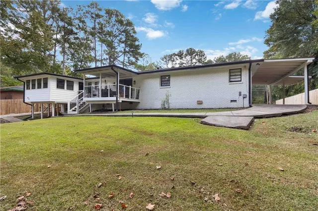a view of a house with a yard and sitting area