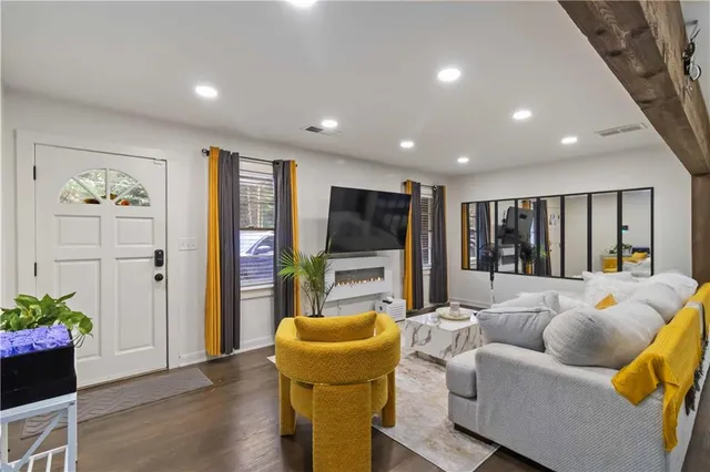 a living room with furniture and a flat screen tv