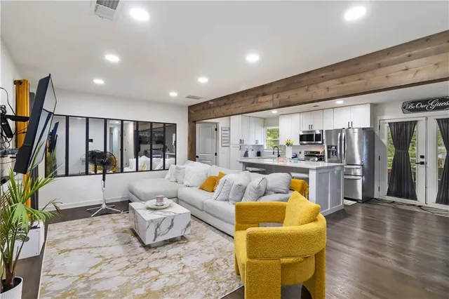 a living room with furniture and a flat screen tv