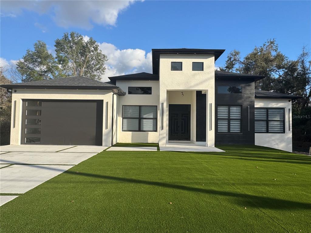17314 Highway 41 Spring Hill, FL 34610 - Photo 1 of 54 a front view of a house with a yard and garage